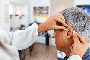Mature man getting fitted for hearing aids